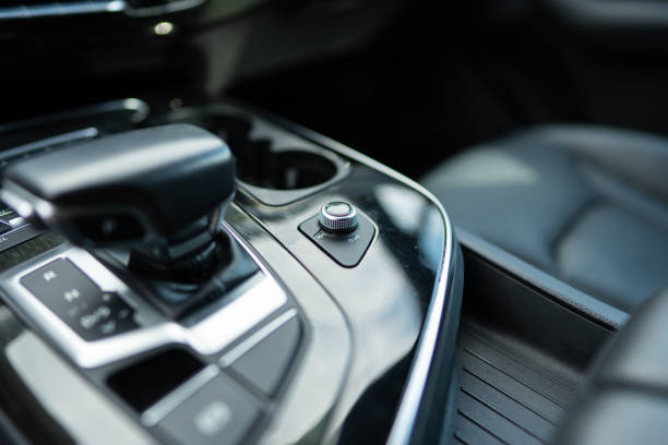 istock Multimedia system controller near gear shift on central console of modern automobile. Mechanical scroll allowing to adjust volume by twisting up or down during drive 1744380695
