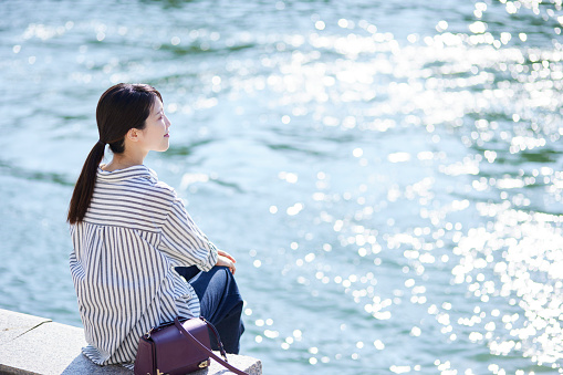 Japanese woman relaxing by the river