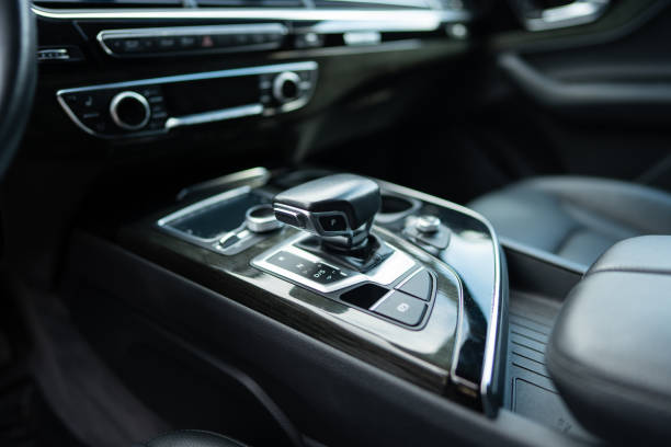 istock Gear shift on centre console between driver's and passenger seats of expensive vehicle. Lever of manual transmission in elegant design 1744382421