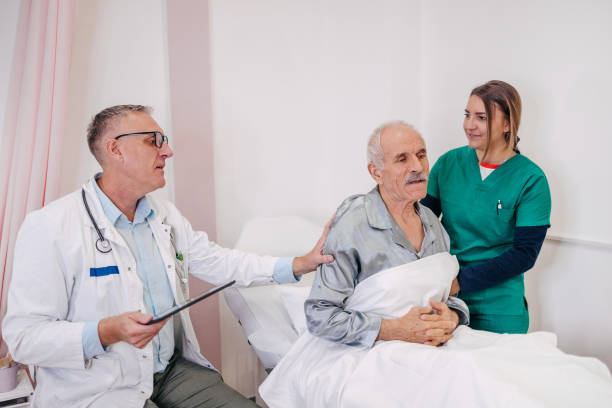 istock Old man having doctor visit at hospital 1744383758