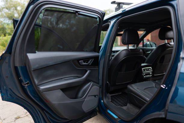 Rear passenger's door of luxury automobile being opened while vehicle being parked in urban area. Clear lines and stylish design of modern car Rear passenger's door of luxury automobile being opened while vehicle being parked in urban area. Clear lines and stylish design of modern car. High quality photo car back open stock pictures, royalty-free photos & images