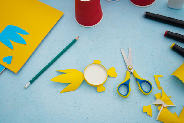 istock 5 - Step by step diy process. Kids craft multicoloured fish from a paper coffee cup, zero waste concept. 1744395466