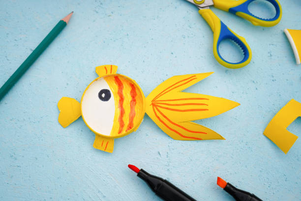 istock 6 - Step by step diy process. Kids craft multicoloured fish from a paper coffee cup, zero waste concept. 1744396810