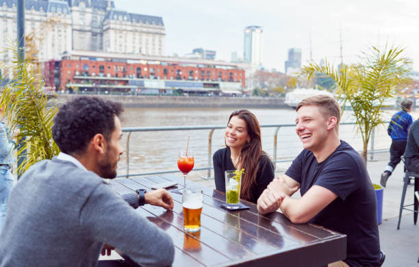 istock group of friends sitting having a drink talking having a good time outdoors with a view of the city streets 1744439850