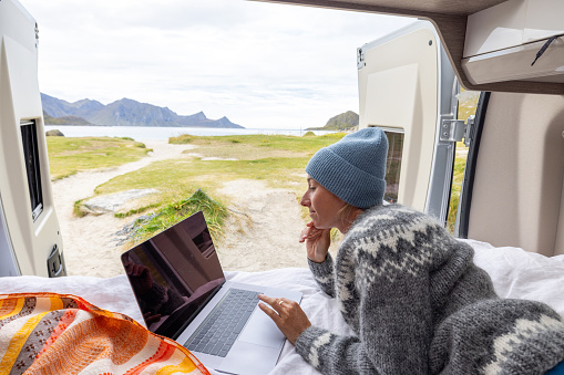 People travel, alternative homes concept. She enjoys the nature right outside a mobile home