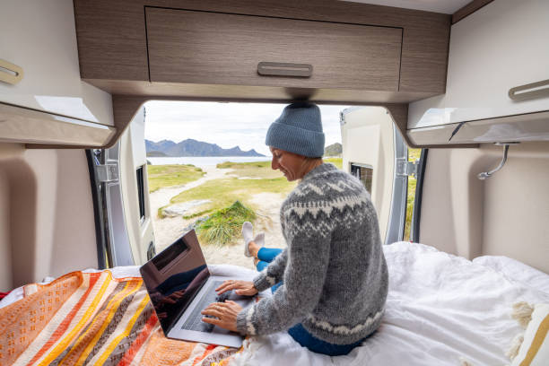 istock Road trip- Woman in a camper van working on laptop 1744443894
