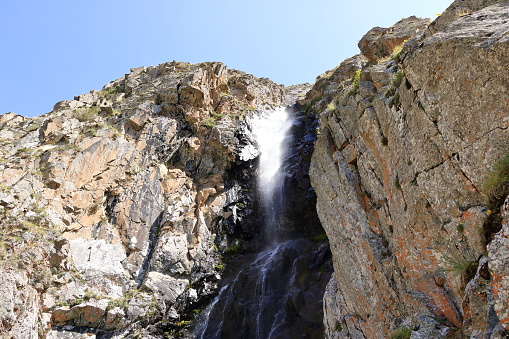 a waterfall in the Ala Archa national Park in summer, Kyrgyzstan in Central Asia