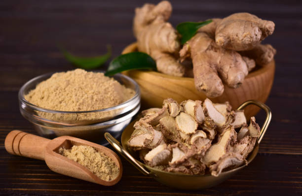 istock Fresh ginger root, dried ginger and ginger powder on a dark wooden background. 1744460355