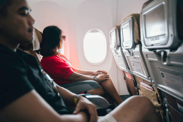 istock woman looking out the window in the airplane 1744460914