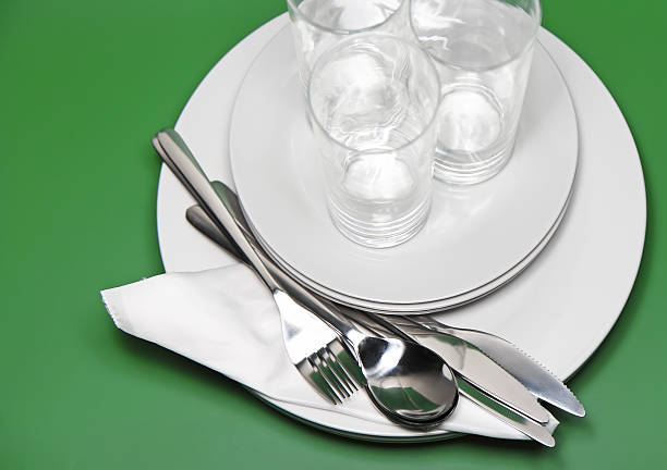 istock Pile of white plates, glasses, forks, spoons. 174446439