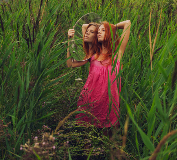 happy young black woman in a red dress on the field in sunset light. countryside concept