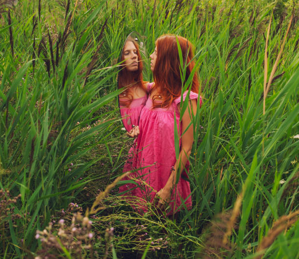Young beautiful woman in green field