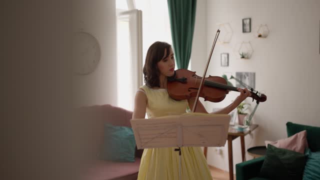 Woman playing violin at home