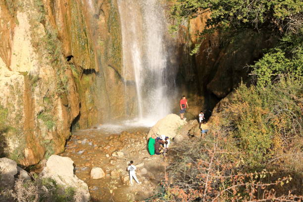 August 21 2023 - Arslanbob, Kyrgyzstan in Central Asia: People at the so-called 'small waterfall' at the top of Arslanbob village, near Jalal-Abad in southern Kyrgyzstan