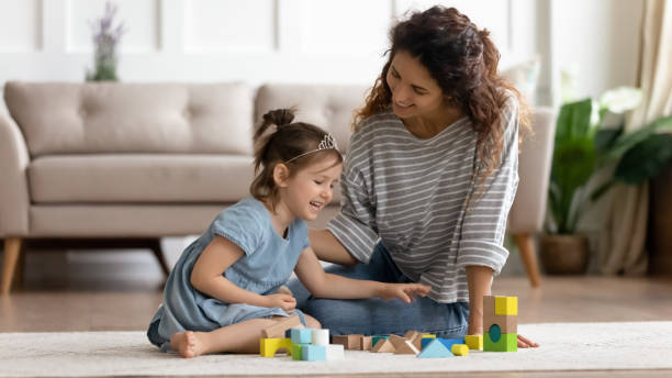 istock Young mom playing with little daughter at home 1744505570
