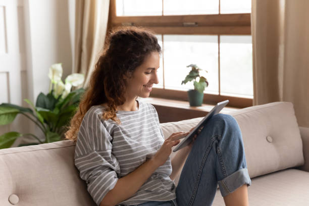 istock Happy young woman browsing internet on tablet 1744507835