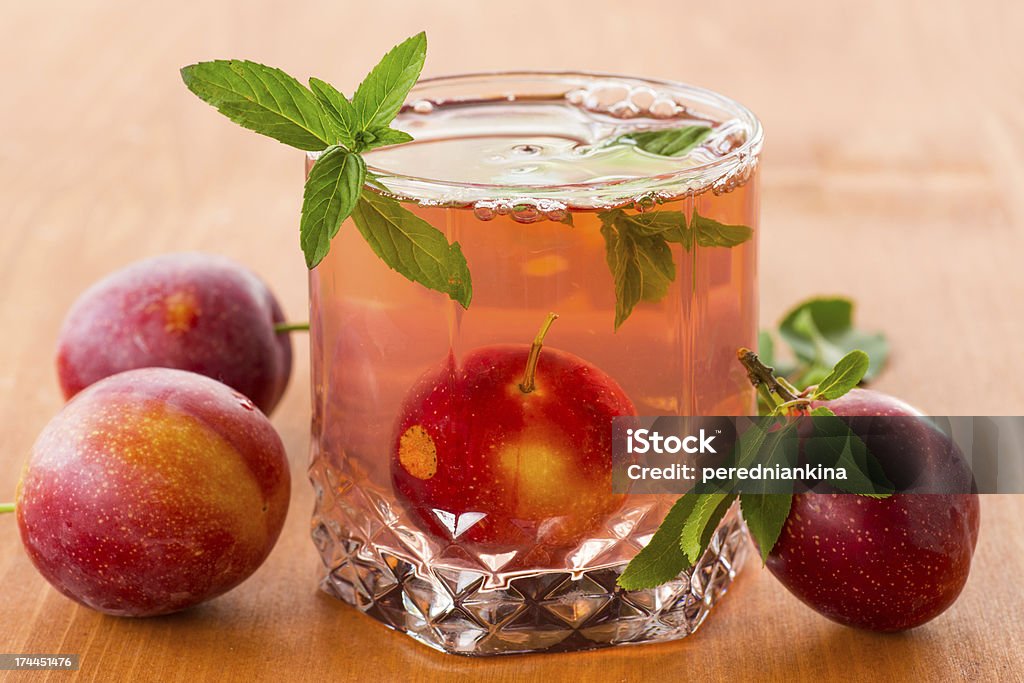 plum compote sweet plum compote in a glass on a wooden table Berry Fruit Stock Photo