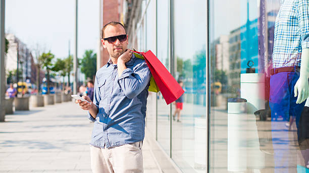 istock Man shopping with many colored bags in his hand 174451700
