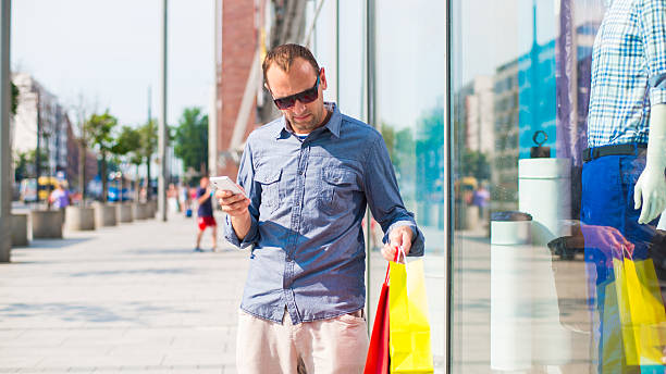 istock Man shopping with many colored bags in his hand 174451724