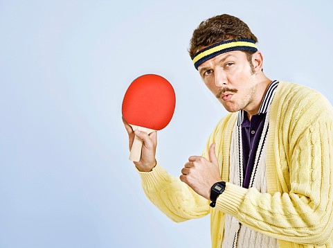 Portrait of man with retro style with ping pong raquet