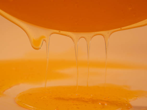 istock Liquid shower gel flows gracefully across a bright orange background. 1744521424