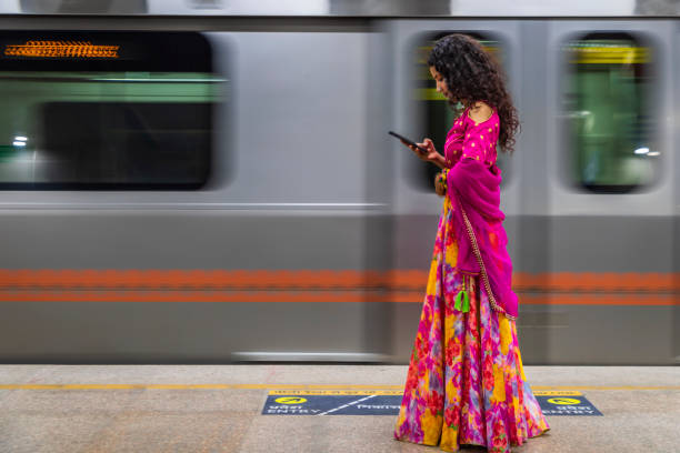 istock Indian girl using a mobile phone at metro station, India 1744535037