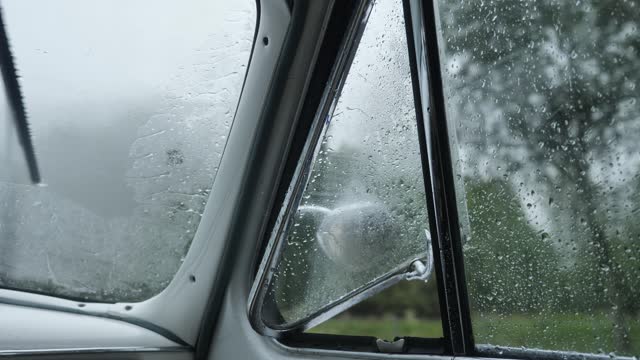 Moving Retro Car with Window and Rear View Mirror at Rain Close Up