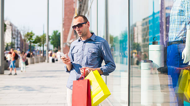 istock Man shopping with many colored bags in his hand 174454648