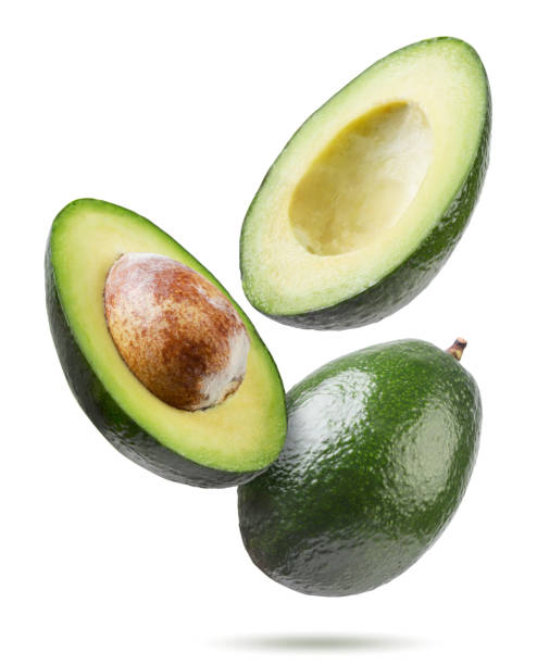istock Ripe avocado and two halves flyon a white background. Isolated 1744559198