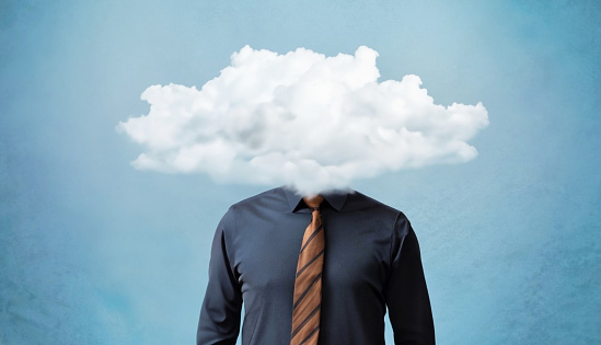 Solitude and depression concept. Businessman with cloud over his head. Loneliness and anxiety.