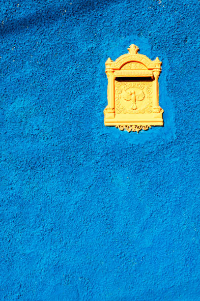 Yellow mailbox on blue wall. Contrast. Space for advertising. (mailbox).