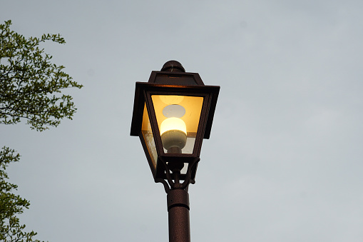 Illuminated street lamp in the morning.