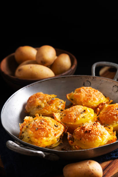 istock Food concept Homemade Gratin potatoes stack on black background with copy space 1744580015