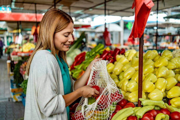 istock Costumer choosing vegetables in a grocery in open market. 1744580755