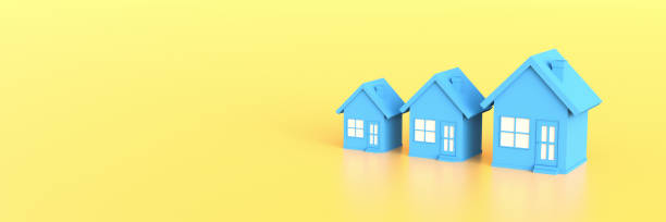 Blue house on yellow background with empty copy space. Hunting and searching concept stock photo