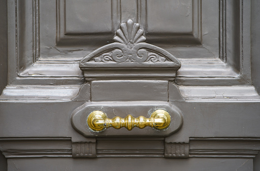 Decorative old French door with bronze handle. PARIS - 29 APRIL,2019