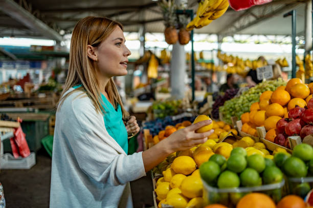istock Woman choosing fruits for diet, checking lemon 1744582888