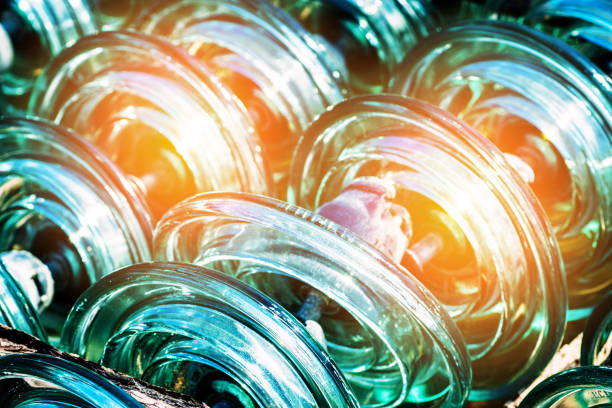 Glass transparent high-voltage insulator is in storage. Industrial background.