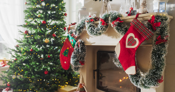 Empty Shot Depicting the Magic of Holidays on a Peaceful Snowy Christmas Morning: Decorated Corner in Modern House with Christmas Tree, Fireplace and Gifts. Home of a Family Celebrating with Joy