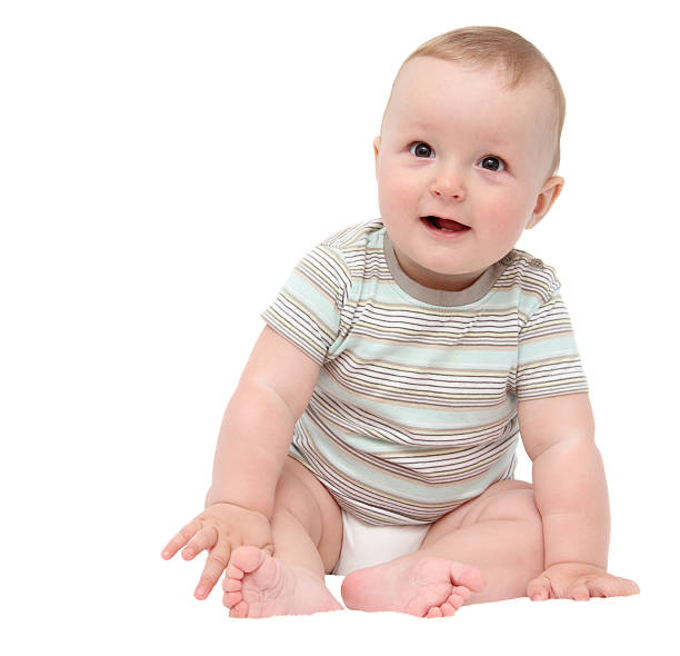 istock beautiful laughing happy baby boy sitting on bed 174464242
