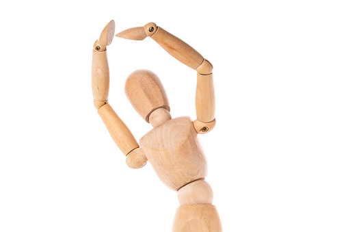 A wooden mannequin depicted holding a knife in each hand. This image can be used to illustrate concepts such as danger, aggression, or the art of knife handling.