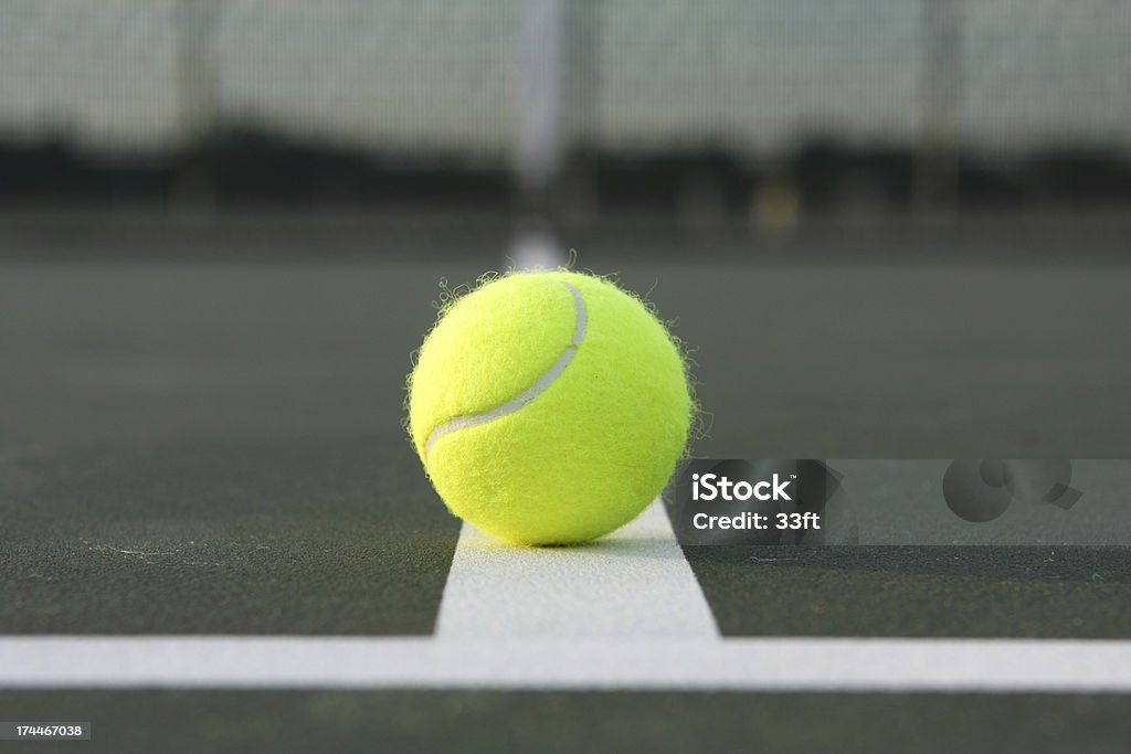 Tennis Ball at the Court Lines Tennis Ball Close Up on the Court Lines Competition Stock Photo
