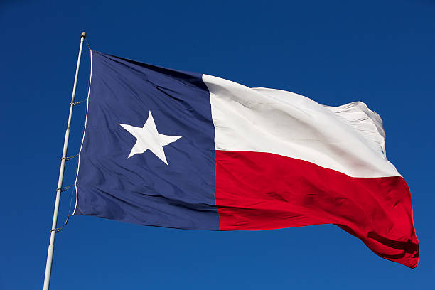 Texas state flag waving in the wind stock photo