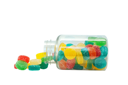 Nutritional supplement gummies jar open on white background