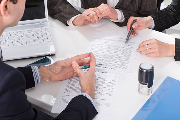 hands of three people, signing documents Three people sitting at a table signing documents, hands close-up shorthand photos stock pictures, royalty-free photos & images