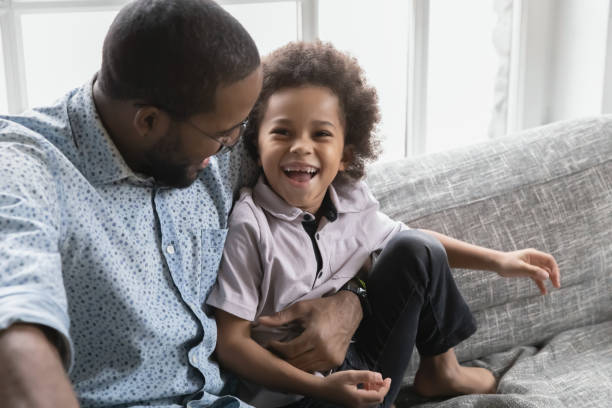 istock Close up African American father and son hugging, having fun 1744699467