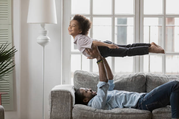 istock Side view African American father and son playing active game 1744700078