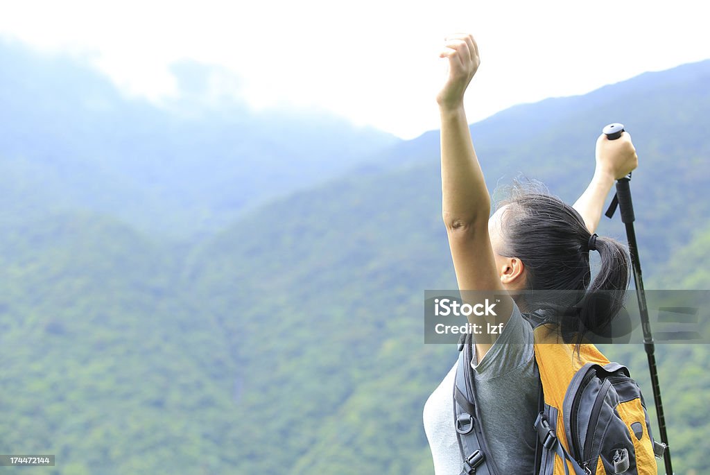 young woman hiker fit young chinese woman hiker happy mountain peak Active Lifestyle Stock Photo