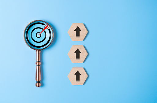 Magnifying glass with dartboard arrow and arrow up icons for business goal objective and target optimization. Successful project plan, Business growth opportunities, and strategy planning management.