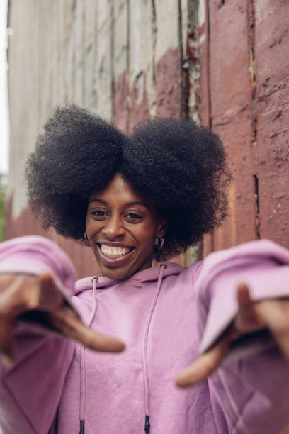 istock Young woman portrait against a red wall 1744738372